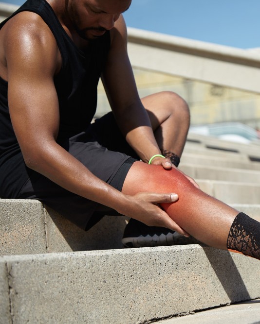 closeup-young-man-with-knee-injury - Muscle Sprain Strains - Image by wayhomestudio on Freepik