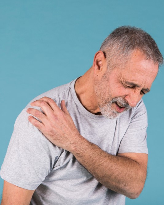stressed-senior-man-with-shoulder-pain-blue-backdrop - Bone And Muscle Pain - Image by freepik 